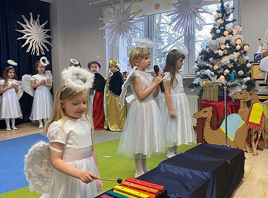 Dziewczynka- aniołek gra na cymbałkach a druga śpiewa