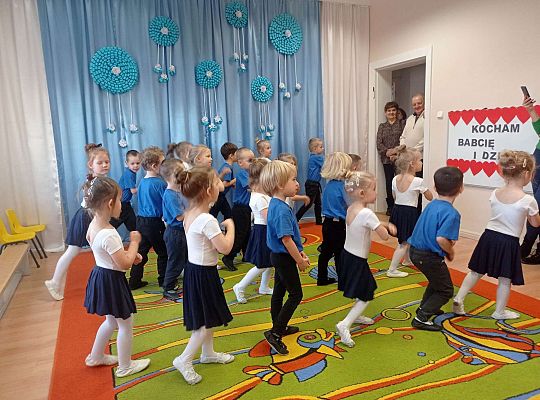 Dzieci tańczą wspólny taniec dla babci i dziadka