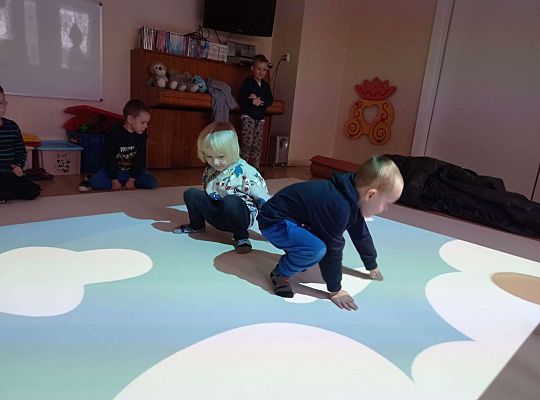 Dzieci zbijają balony naskakując na nie