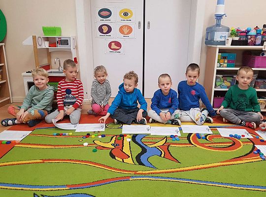 Dzieci układają zakrętki na pięciolinii