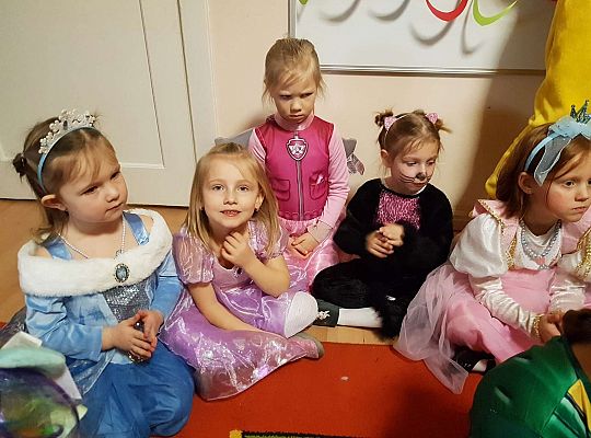 Dzieci siedzą na dywanie