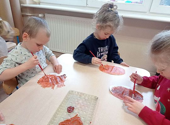 Dzieci malują farbami pączki z papieru