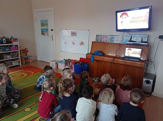 Dzieci oglądają film edukacyjny o Historii Tłustego Czwartku