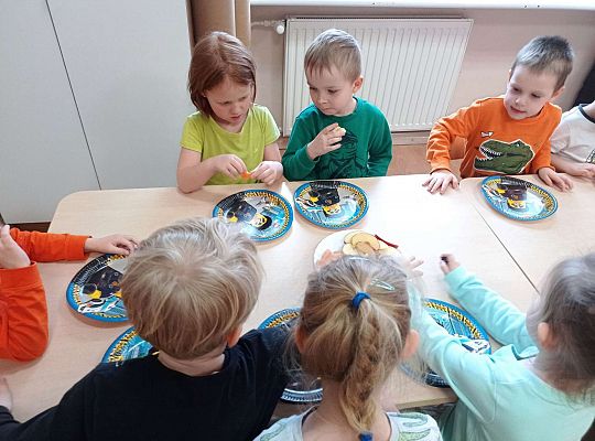 Dzieci jedzą urodzinowe owoce