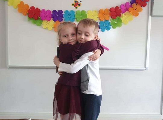 Chłopiec wręcza dziewczynce laurkę