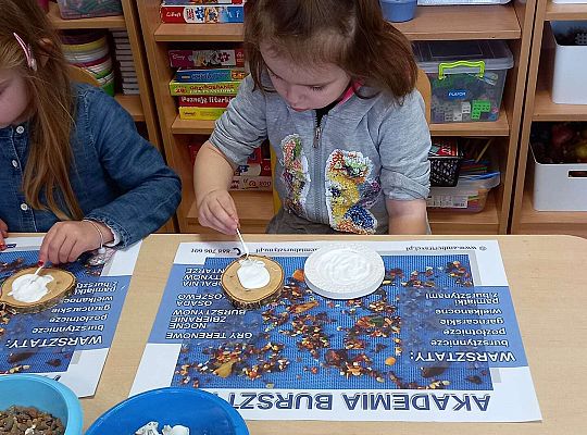 Dzieci układają bursztyn i muszelki