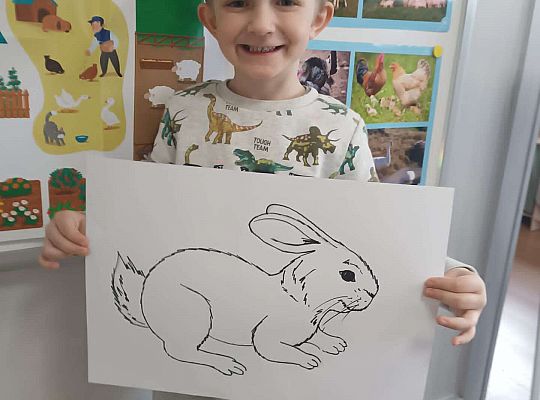 Chłopiec prezentuje szkic królika