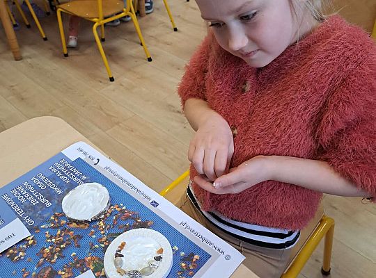 Dziewczynka wykonuje prace z bursztynem