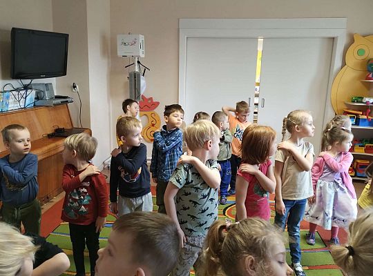 Dzieci wykonują ćwiczenia gimnastyczne