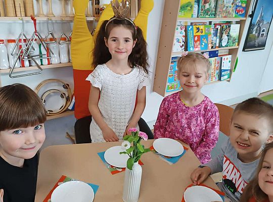 Dzieci przy stole z poczęstunkiem