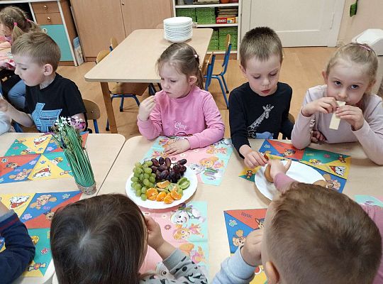 Dzieci jedzą owoce i ciastka